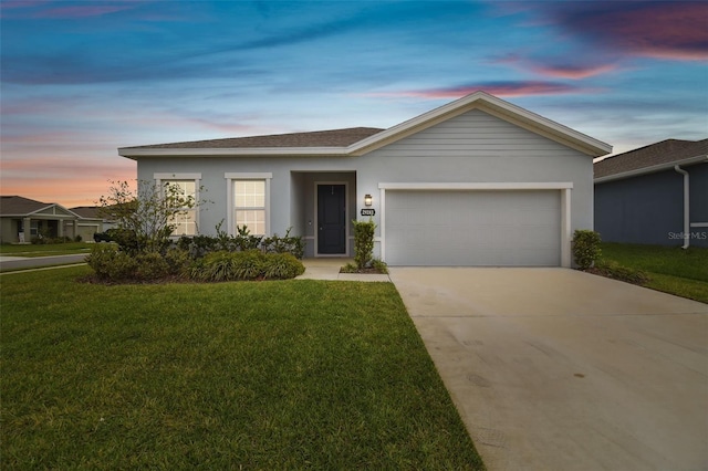 ranch-style house with a garage, a shingled roof, driveway, stucco siding, and a front yard