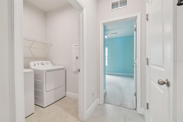 washroom with laundry area, baseboards, visible vents, and tile patterned floors