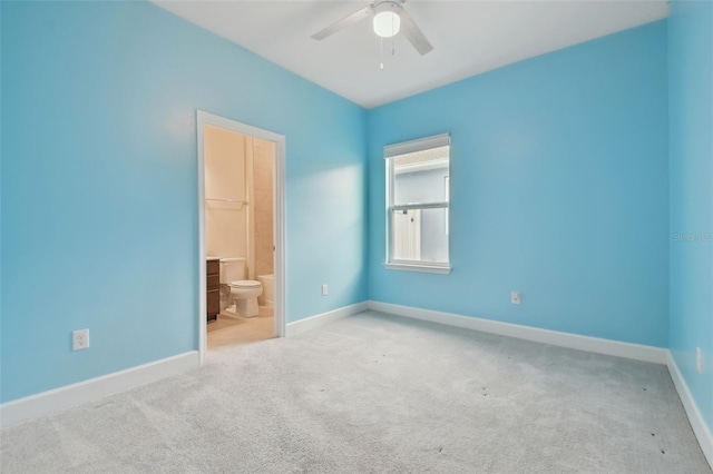 spare room with carpet floors, ceiling fan, and baseboards