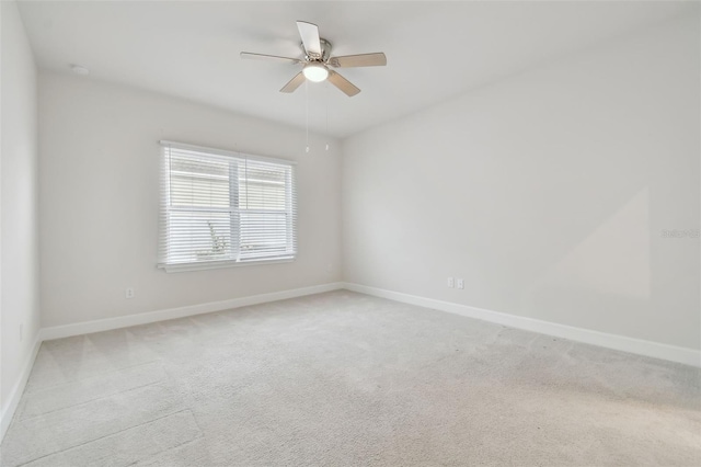 unfurnished room featuring light carpet, ceiling fan, and baseboards