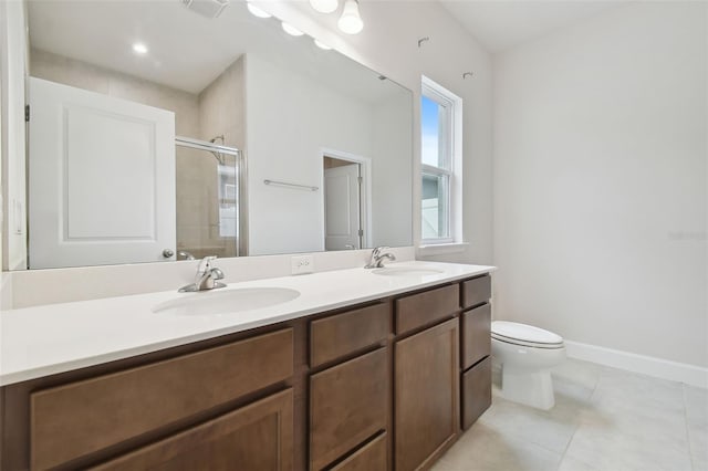 full bathroom featuring toilet, a stall shower, a sink, and tile patterned floors