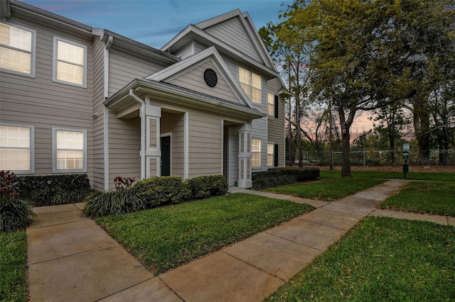 view of front of property with fence and a front yard