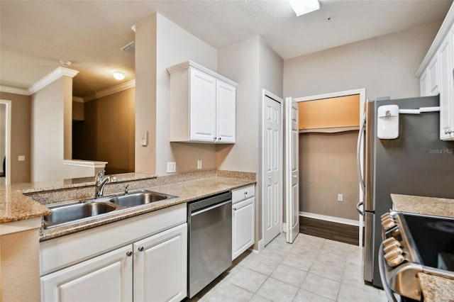 kitchen with baseboards, ornamental molding, stainless steel appliances, white cabinetry, and a sink