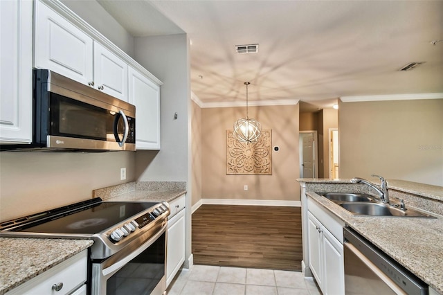 kitchen featuring white cabinets, visible vents, stainless steel appliances, and a sink