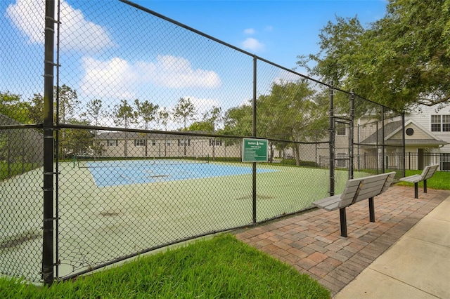 view of sport court with fence