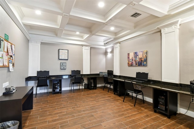 office space with ornate columns, visible vents, built in desk, and wood finish floors