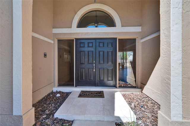 entrance to property with stucco siding