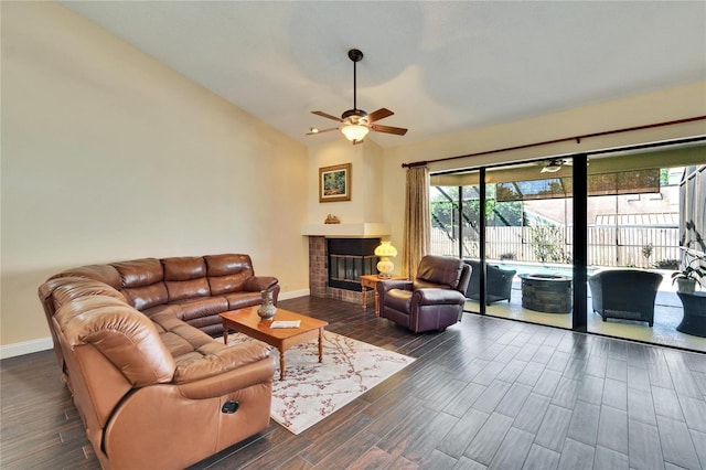 living room with a glass covered fireplace, vaulted ceiling, baseboards, and wood finished floors