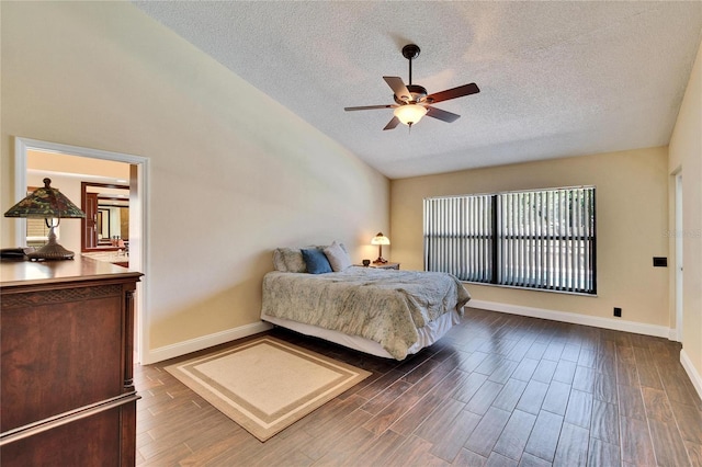 bedroom featuring dark wood-style floors, vaulted ceiling, a textured ceiling, ceiling fan, and baseboards