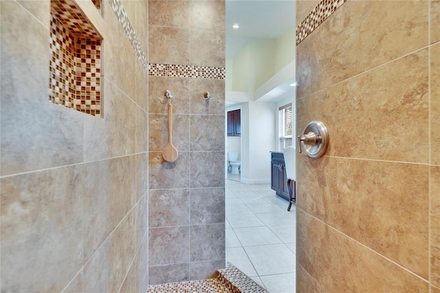 bathroom with recessed lighting, tiled shower, and tile patterned floors