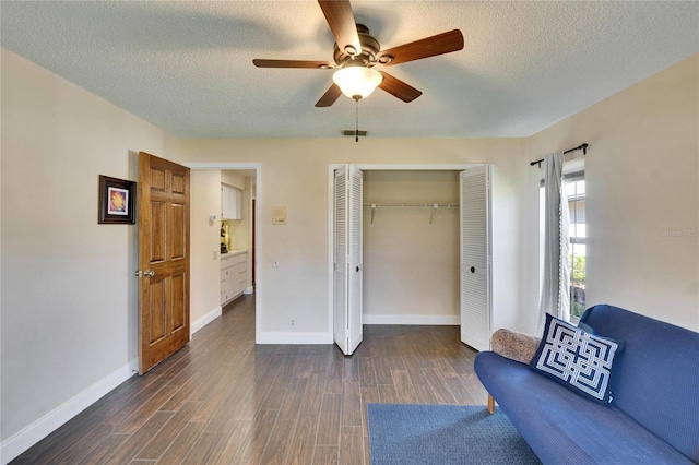 interior space with dark wood-style floors, visible vents, a textured ceiling, and baseboards