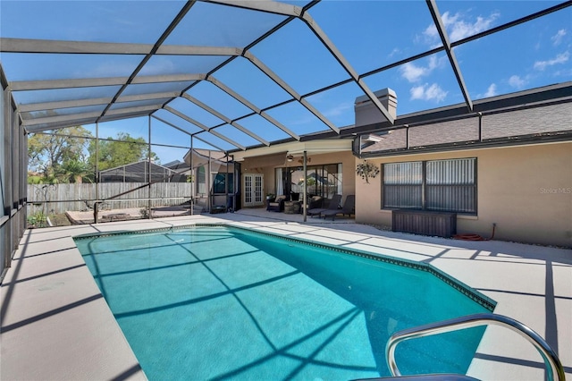 view of swimming pool with a fenced in pool, a patio, a lanai, fence, and french doors