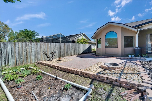 view of yard with a fenced backyard, a patio, and a fire pit