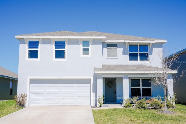 traditional home with an attached garage, driveway, and stucco siding