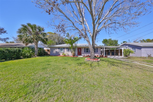 ranch-style house featuring an attached carport and a front lawn