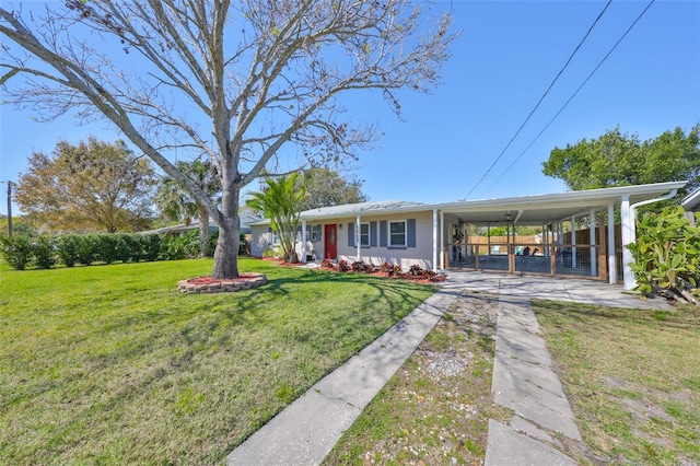 view of front facade with a carport, a front yard, and concrete driveway