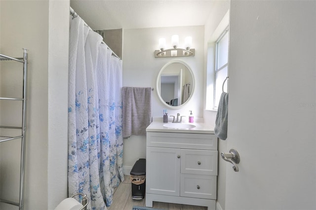 full bath with vanity, a shower with shower curtain, and wood finished floors