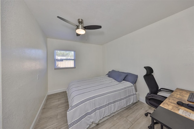 bedroom featuring baseboards, a ceiling fan, and wood finish floors