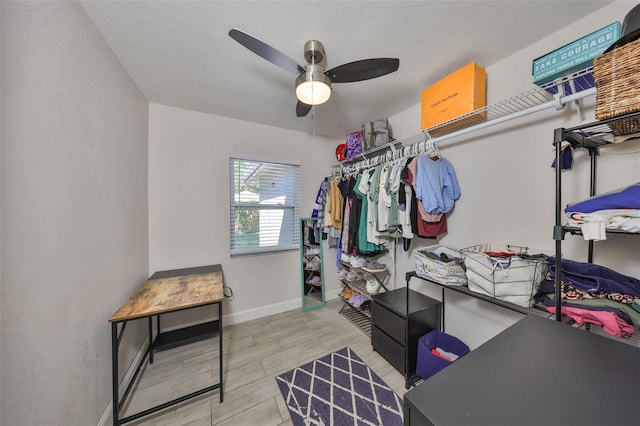 spacious closet with a ceiling fan