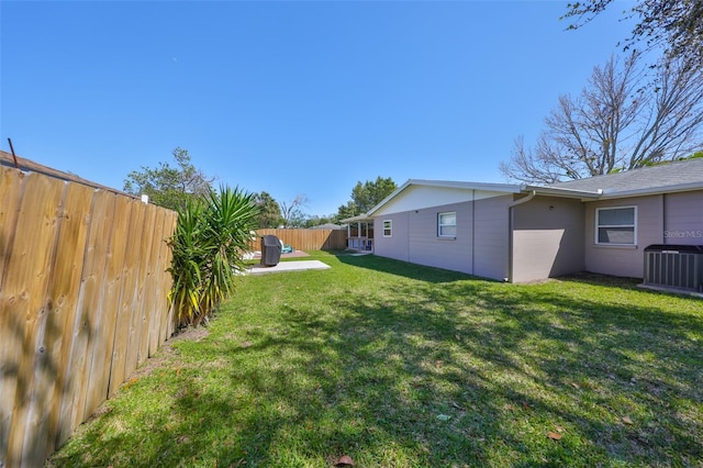 view of yard featuring a fenced backyard, a patio, and central air condition unit