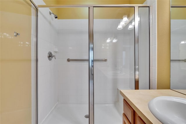 full bathroom featuring a stall shower and vanity