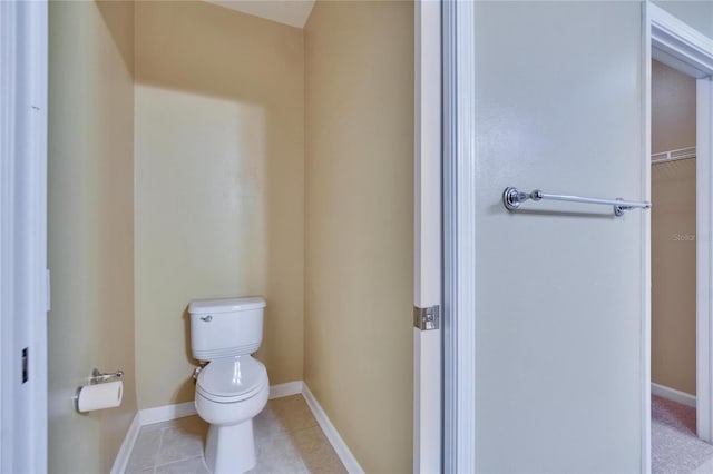 bathroom featuring baseboards, toilet, and tile patterned floors