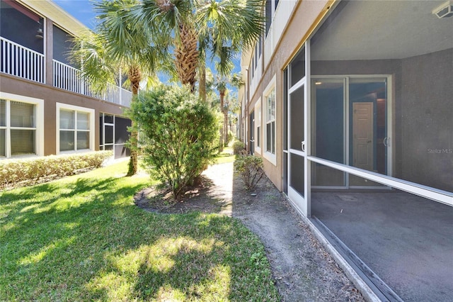 view of yard with a sunroom and visible vents