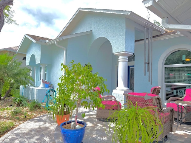 2069 Overbrook Ln, Spring Hill, FL 34606 - view of side of property featuring stucco siding and a patio