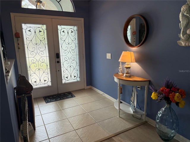 2069 Overbrook Ln, Spring Hill, FL 34606 - foyer with french doors, light tile patterned flooring, and baseboards