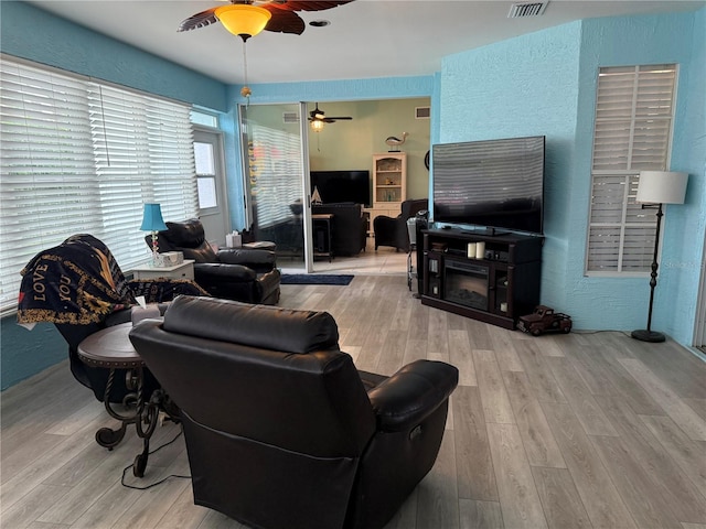 2069 Overbrook Ln, Spring Hill, FL 34606 - living room featuring a ceiling fan, wood finished floors, and a textured wall