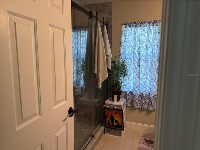 2069 Overbrook Ln, Spring Hill, FL 34606 - bathroom featuring tile patterned flooring, a stall shower, and baseboards