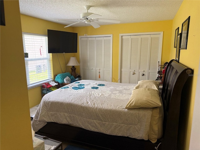 2069 Overbrook Ln, Spring Hill, FL 34606 - bedroom featuring multiple closets, a textured ceiling, and ceiling fan