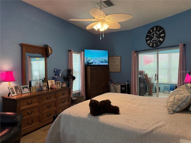 2069 Overbrook Ln, Spring Hill, FL 34606 - bedroom featuring wood finished floors, ceiling fan, and a textured ceiling
