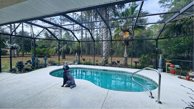 outdoor pool with glass enclosure and a patio