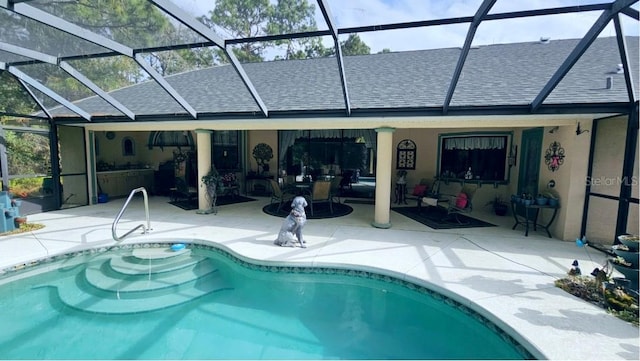 pool featuring a patio area and glass enclosure