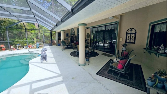 pool with a lanai and a patio area