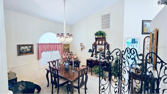 dining room with an inviting chandelier and vaulted ceiling