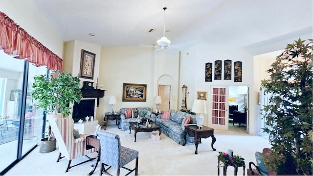 carpeted living area featuring visible vents and ceiling fan