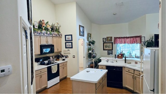 kitchen with a kitchen island, dark wood-type flooring, black appliances, and light countertops