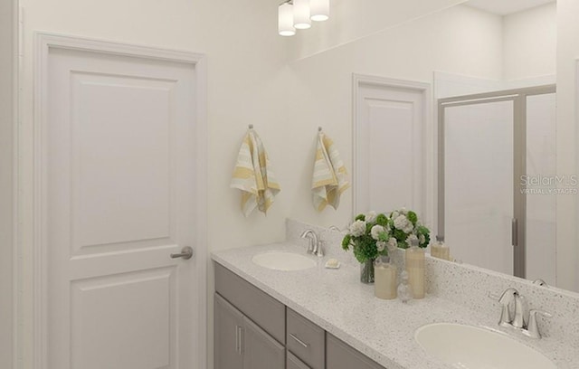 bathroom featuring double vanity, a stall shower, and a sink