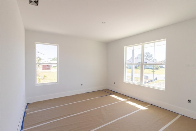 spare room with baseboards