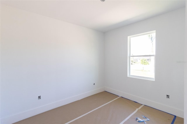 unfurnished room featuring baseboards