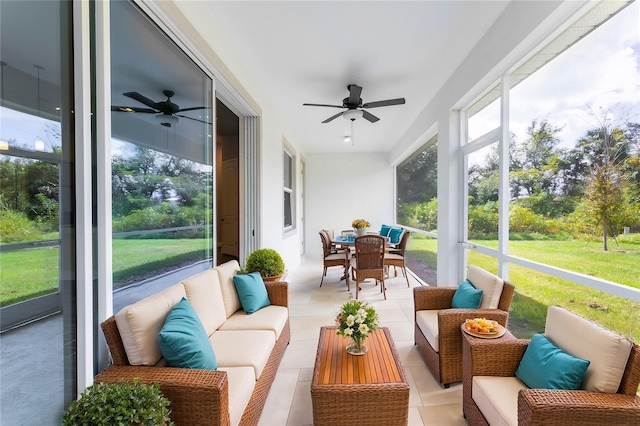 sunroom / solarium featuring ceiling fan