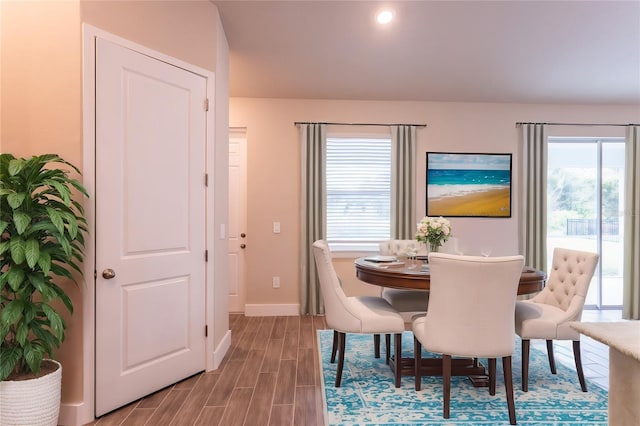 dining space with wood finished floors and baseboards