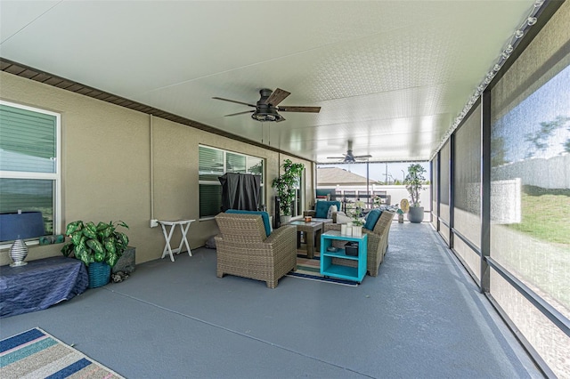 sunroom / solarium with a ceiling fan