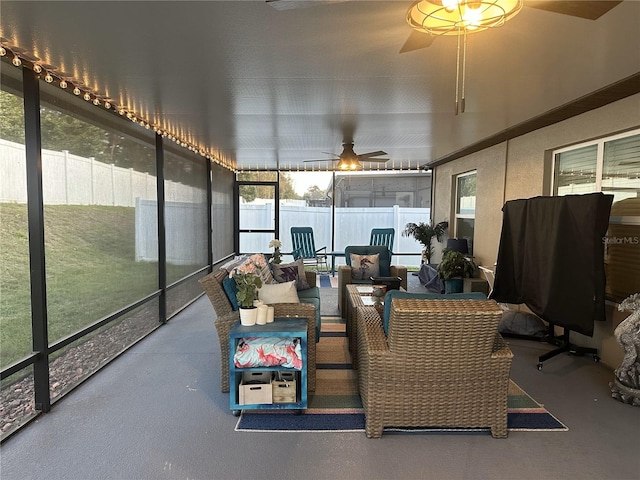 sunroom featuring a ceiling fan