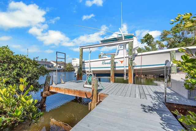 dock area with a water view and boat lift