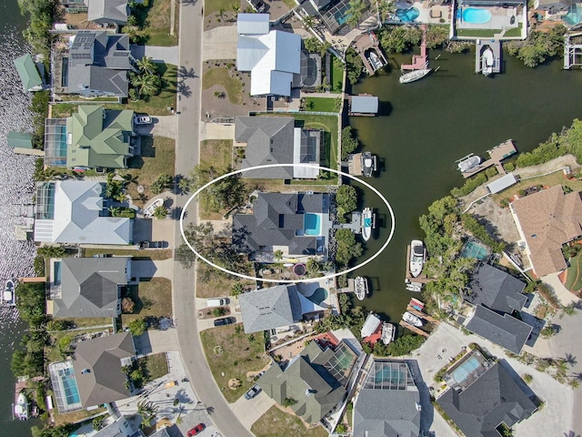 birds eye view of property with a water view and a residential view