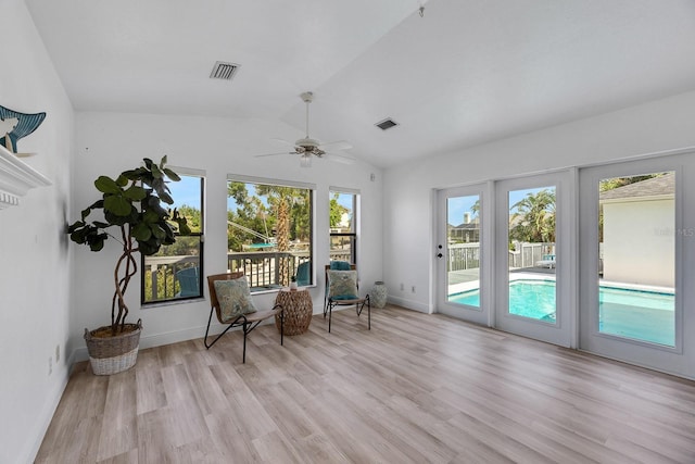 unfurnished room with lofted ceiling, baseboards, visible vents, and light wood finished floors