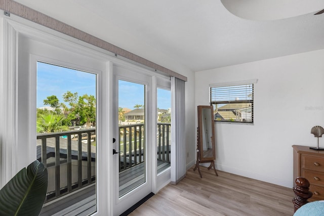 entryway featuring light wood-style floors and baseboards